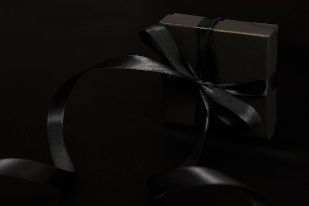 Black friday sale concept with gift box with ribbon, close-up