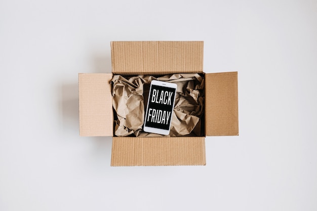 Photo black friday sale deals concept packing box gifts and cell phone with text black friday flat lay