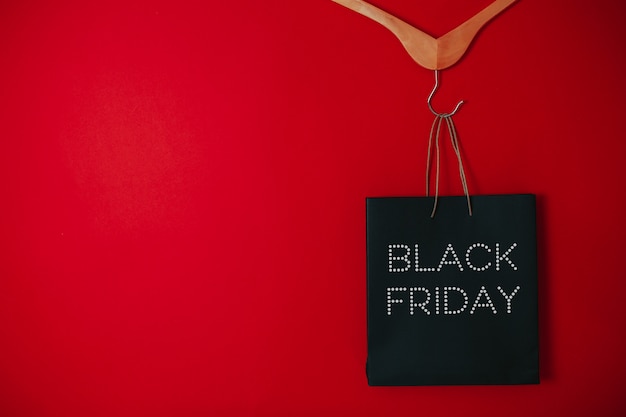 Black friday sale flat lay, Black friday bag, Hangers on the red surface,