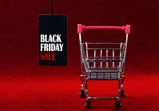 Black Friday Sale label with supermarket trolley on dark red background