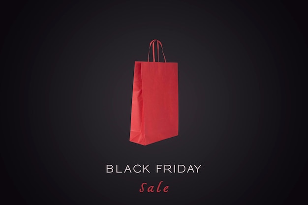 Photo black friday sale sign and a red paper bag in a black background