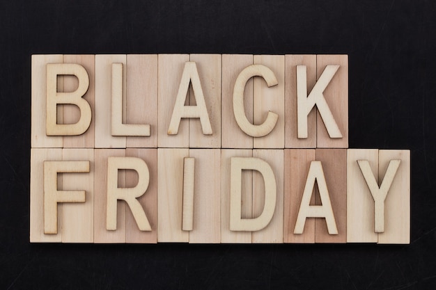 Black Friday - text in wooden letters on blackBoard. Copy space.