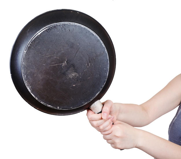 Black frying pan in female hands