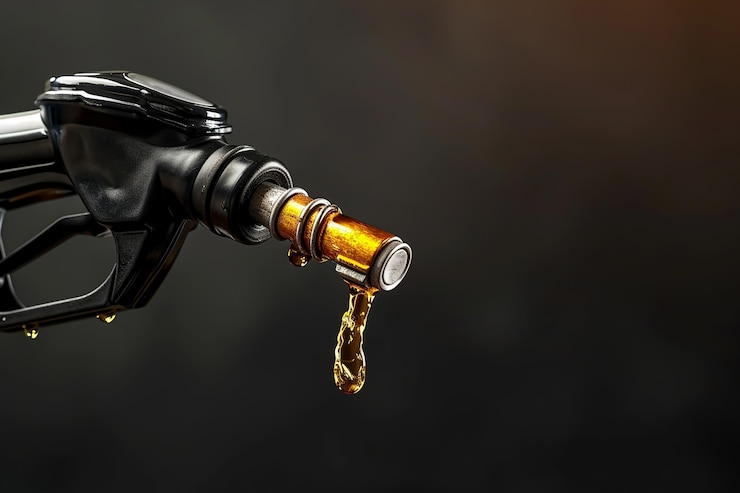 Photo black gasoline injector fueling oil or pure fuel on dark background flexible hose for refueling a car with gasoline diesel fuel