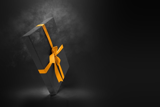 Black gift box cap with a golden ribbon on black background. Black Friday concept