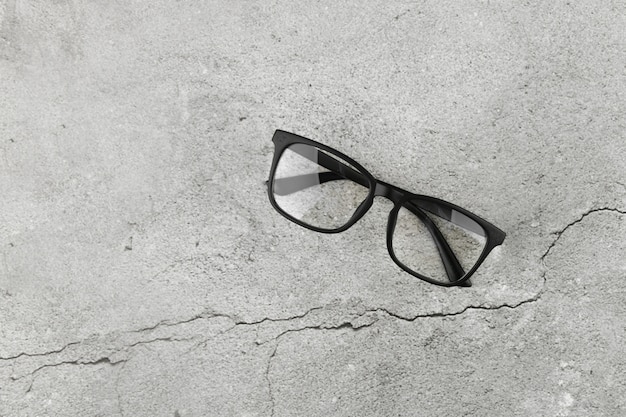 Black glasses on concrete background. two pairs of 3d glasses on a gray concrete background. top view, copy space. two pairs of 3d glasses on a gray concrete background. top view, copy space