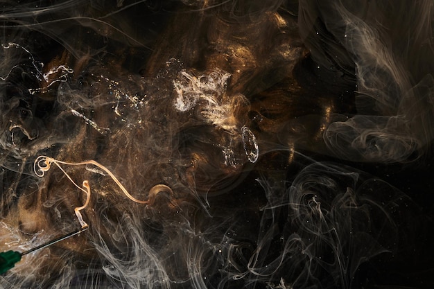 Black gold abstract ocean background Splashes and waves of sparkling paint under water clouds of interstellar smoke in motion