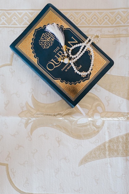 Black and Gold Book on White and Brown Floral Textile