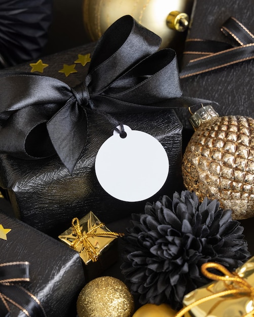 Black and golden Christmas Gift Boxes and ornaments round gift tag Mockup