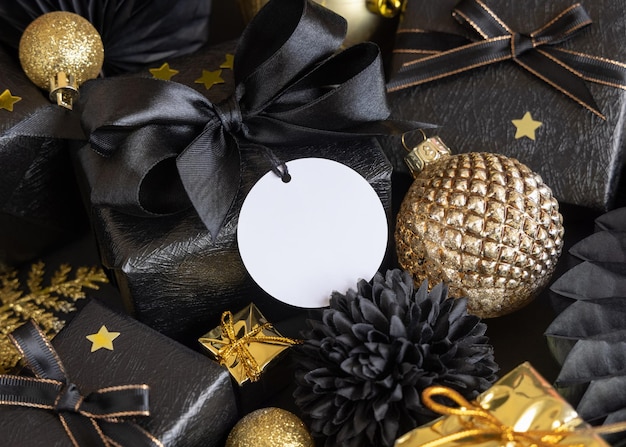 Black and golden Christmas Gift Boxes and ornaments round gift tag Mockup