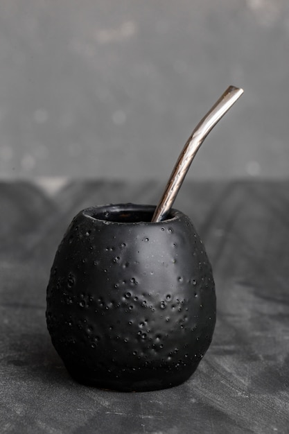 Black gourd with sipped metal straw