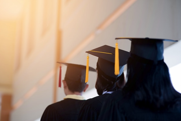 black graduates wear black suits on graduation day at university.