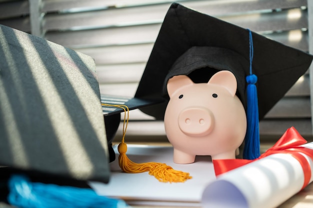 Black graduation hat and piggy bank concept investment in
education graduation save money for education