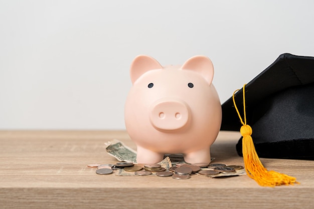 Black graduation hat and piggy bank concept investment in
education graduation save money for education