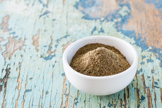 Black ground pepper in small white bowl