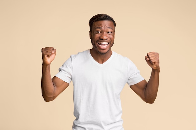 Black Guy Shouting Shaking Fists Standing On Yellow Background