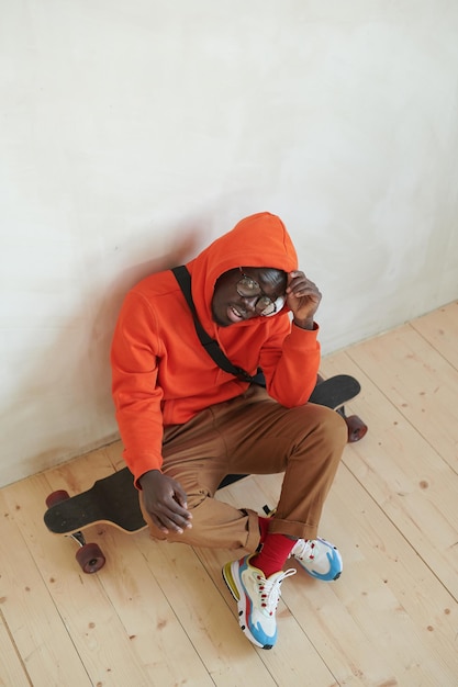 Black Guy Sitting On Skateboard