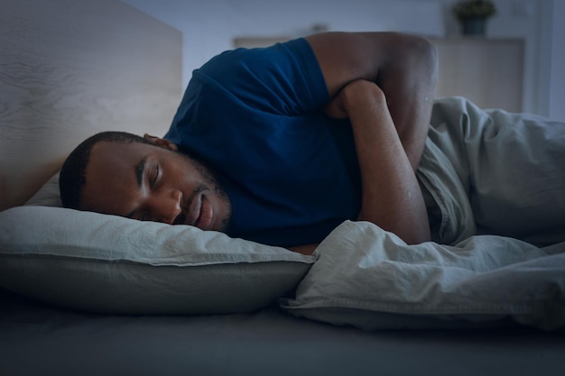 Black Guy Sleeping Lying In Bedroom At Home At Night