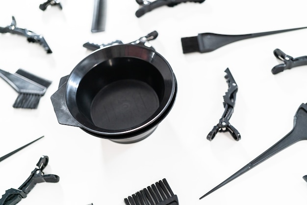 Black hair color dye kit with mixing bowl on a white background.