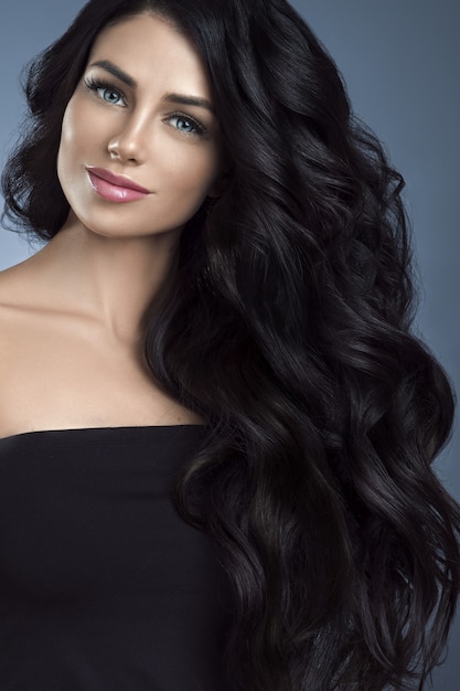 Black hair woman. Beautiful brunette hairstyle fashion portrait long black hair dark background