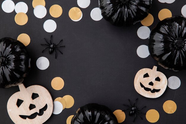 Black halloween lay flat composition with black pumpkins