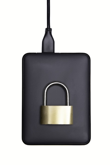 Photo black hard drive with padlock on top on white background