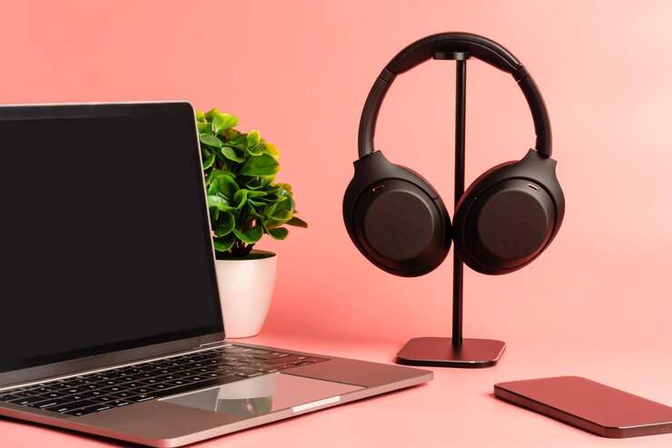Black headphones hang on a table Concept of playing music with a smartphone and listening