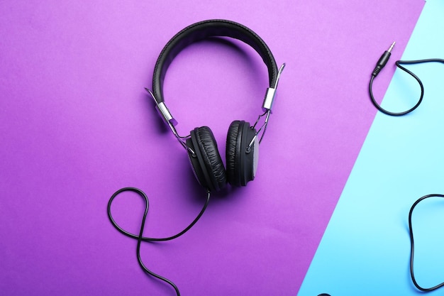 Black headphones on purpleblue background