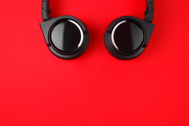 Photo black headphones on the red background music concept