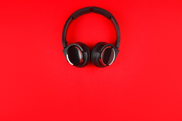 Photo black headphones on the red background music concept