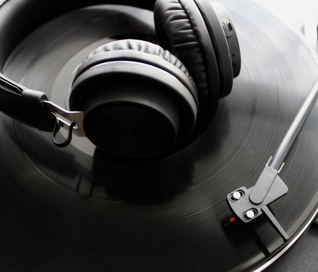 Black Headphones On Vinyl Disc Of Classic Turntable Detailed Top View