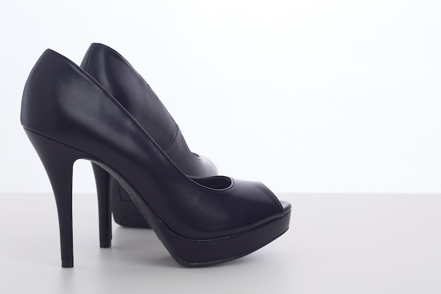 Black high-heeled shoes on white