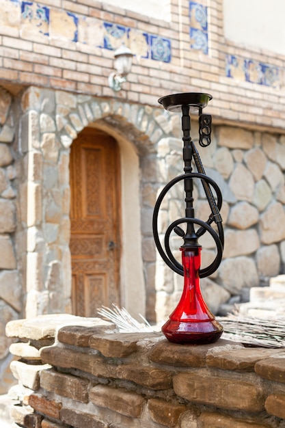 Black hookah with ruby bulb in authentic oriental antique cafe