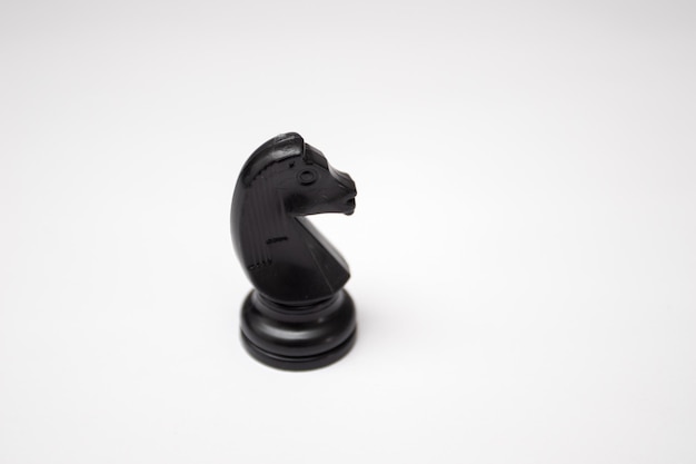 Photo black horse chess piece on white background.