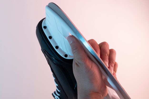 Black ice skates in a man's hands