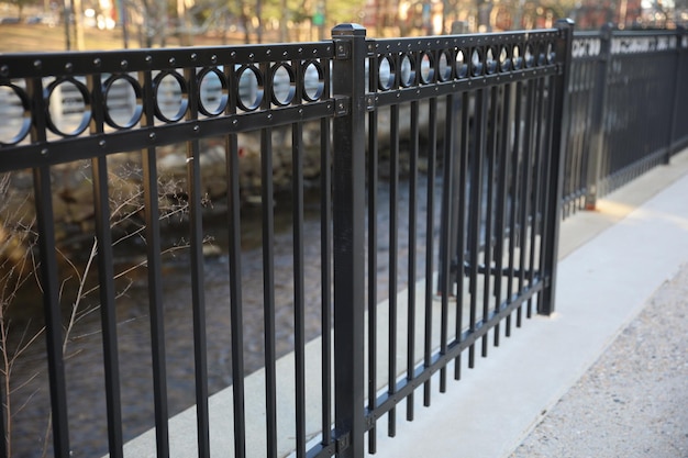 A black iron fence with a circular design on the top.