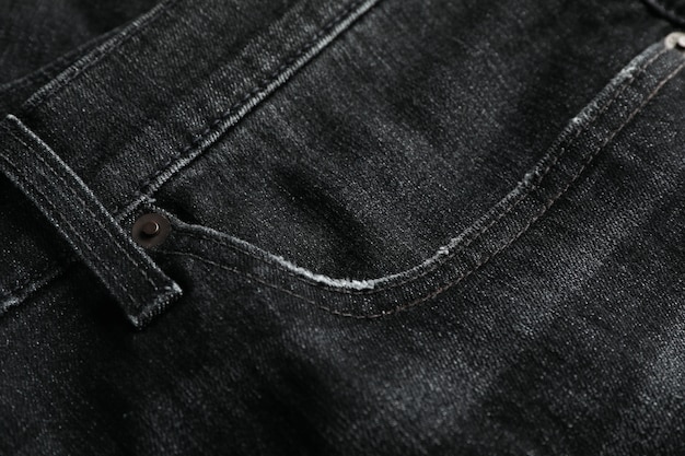 Black jeans textured table close up