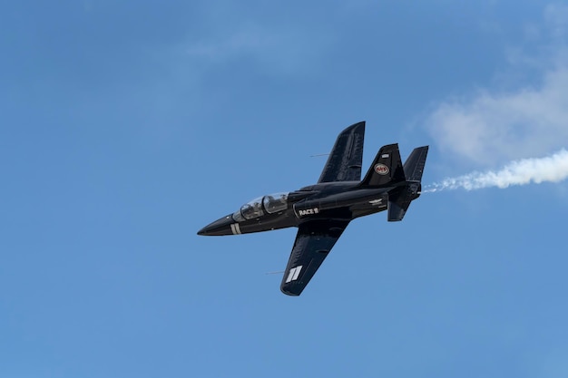 A black jet with the number 2 on it flying in the sky.