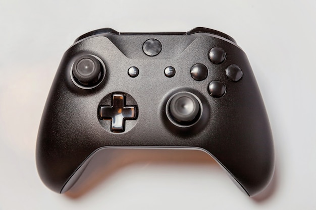 black joystick gamepad, game console isolated on white background. computer gaming videogame concept
