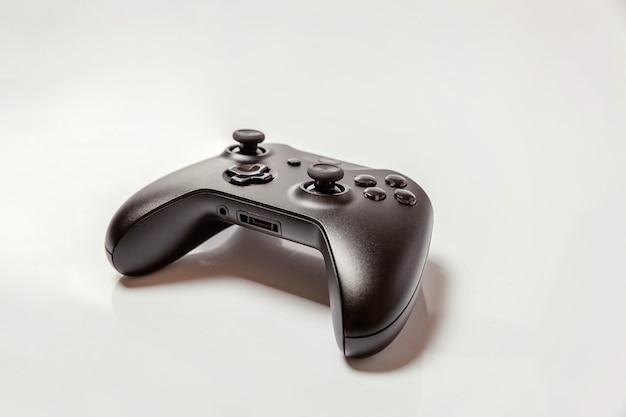 Black joystick gamepad, game console isolated on white