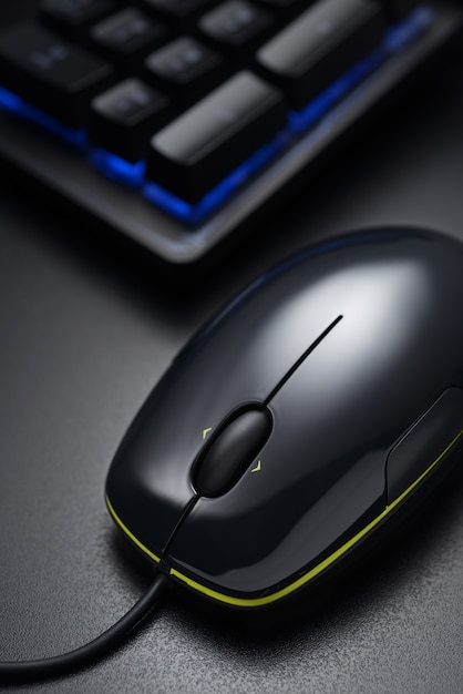 Black keyboard numeric keys and wired mouse on the dark office desk