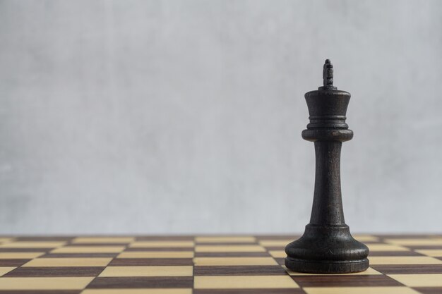 The black king on the empty chessboard