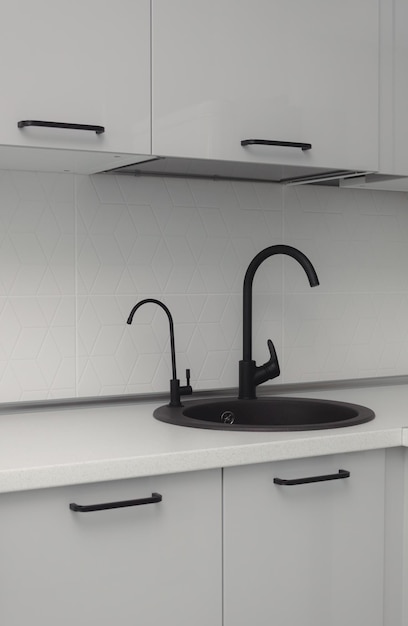 Black kitchen sink with white minimalist backsplash granite countertop gray cabinets and black insulated faucet isolated black sink and faucet black water filtration faucet