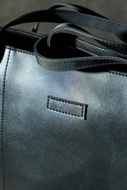 Black leather bag made of genuine leather on a gray background Leather products