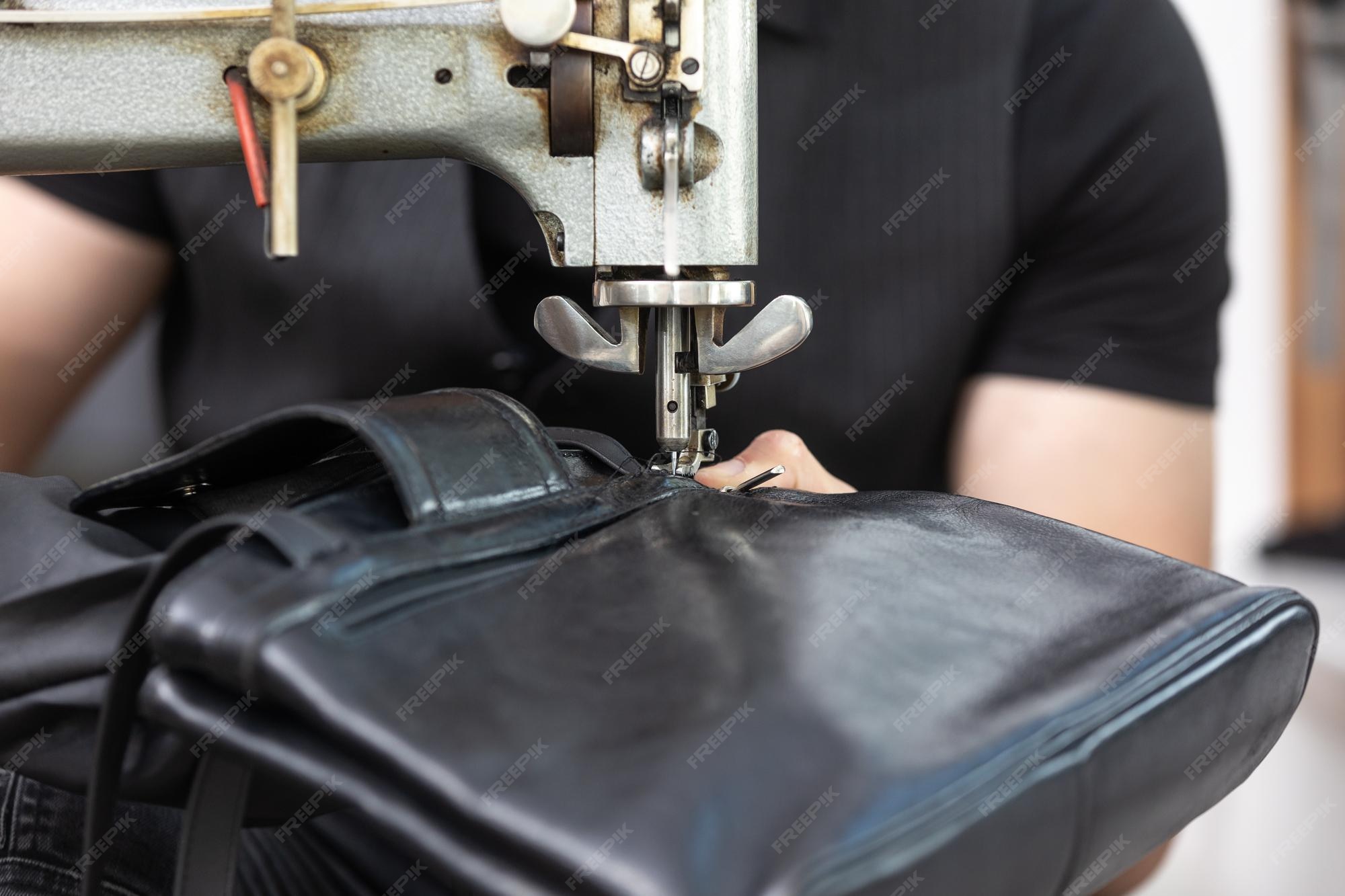 Premium Photo Black leather bag repair in a tailoring studio