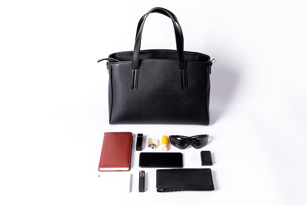 A black leather bag shows what you can hold on a white background