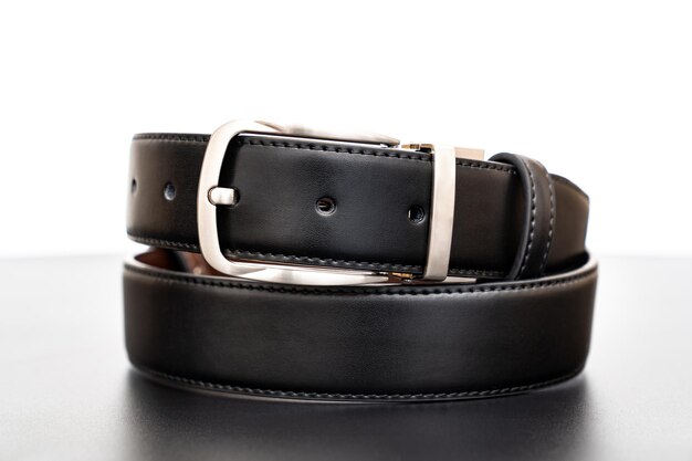 Black leather belt on a black table accessories store for men