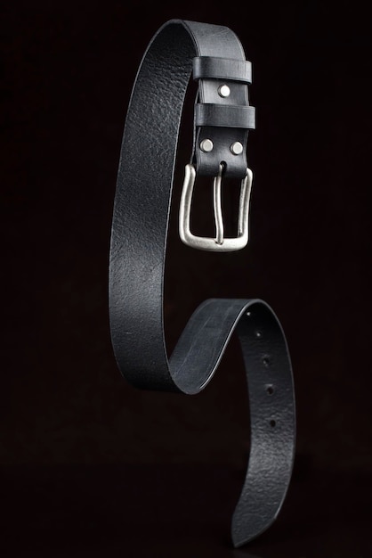 Black leather belt on a dark background Leather products