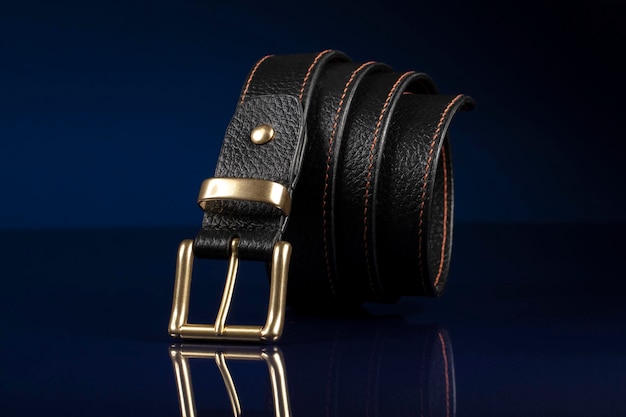 Black leather belt on a dark blue background