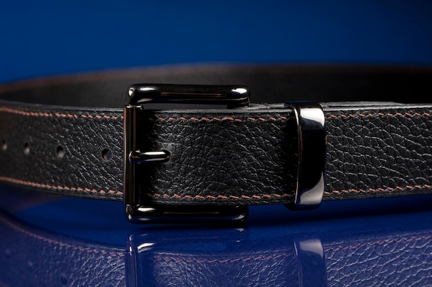 Black leather belt on a dark blue background